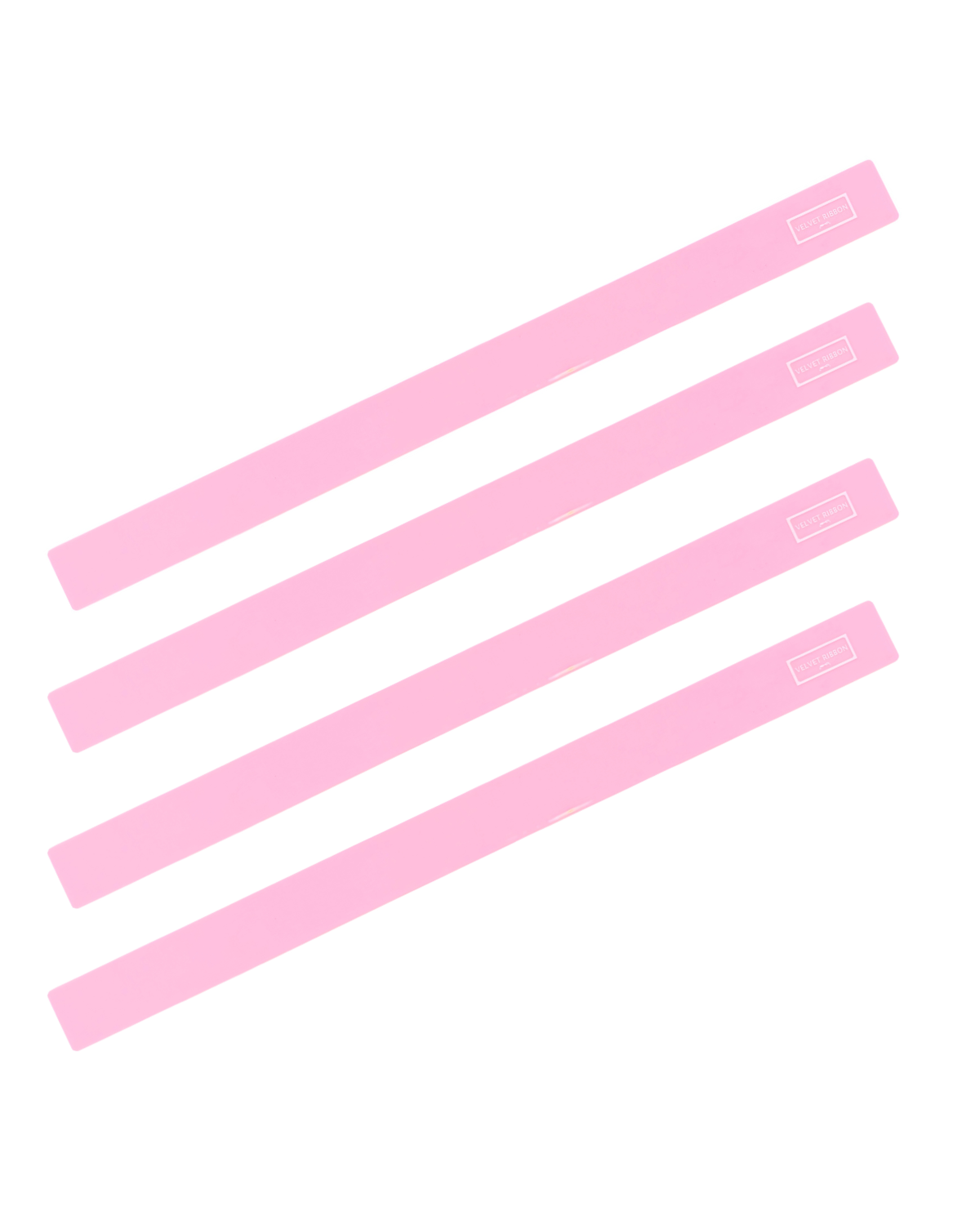 Four light pink rectangular Mahjong Rulers diagonally on a plain white background.