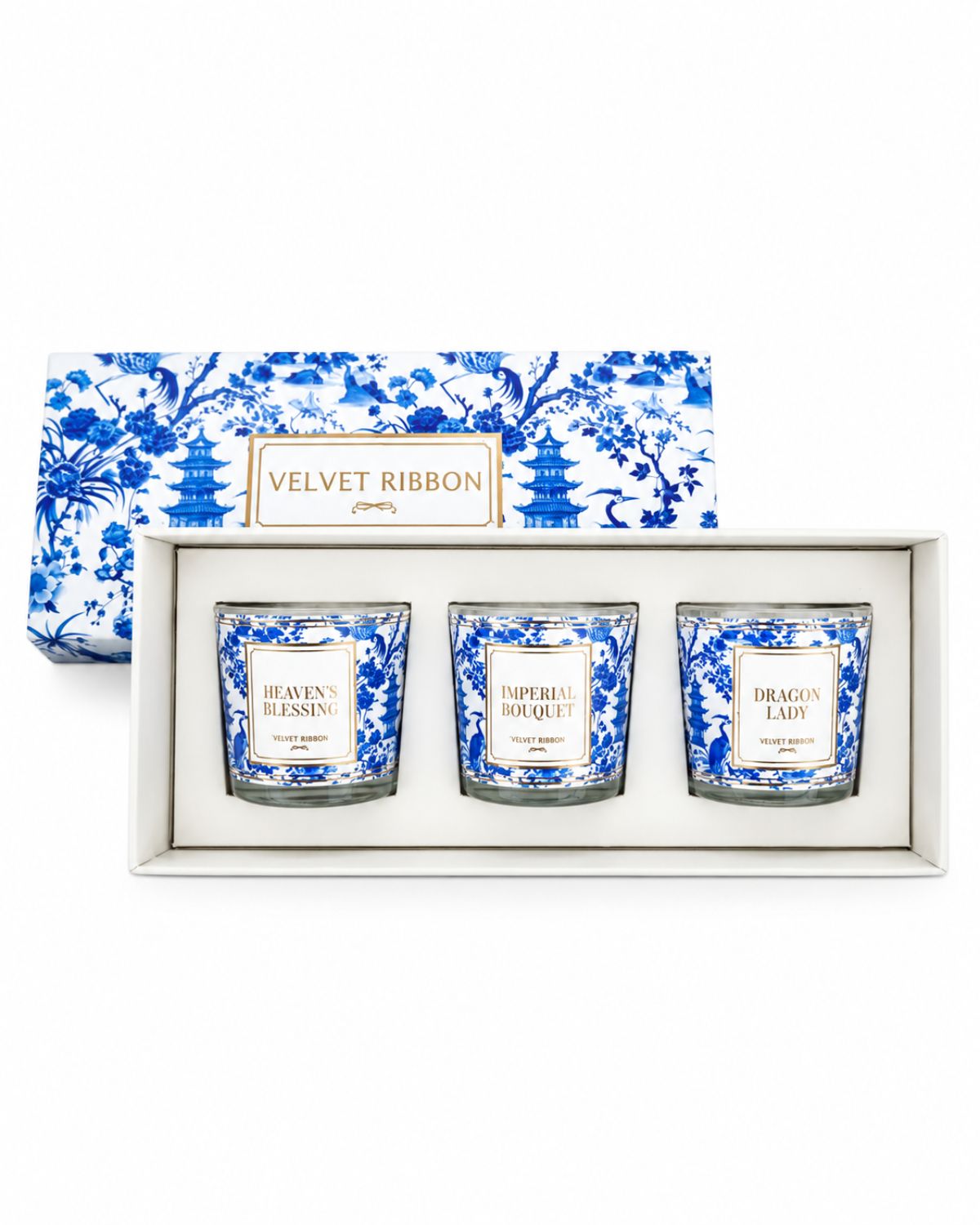 Three scented candles in a white gift box with a blue and white porcelain-style patterned lid. The labels read Heaven's Blessing, Imperial Bouquet, and Dragon Lair, and the box is labeled Velvet Ribbon.